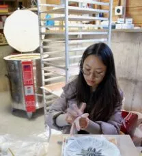 PhD student making a ceramic sculpture with their hands