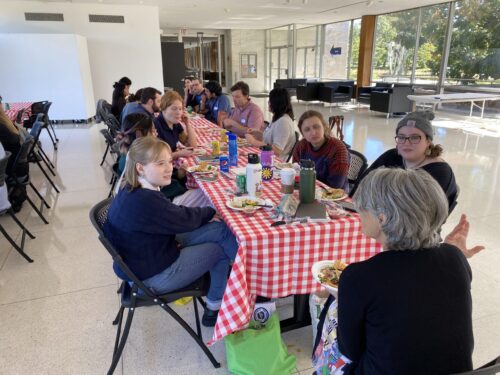 professor anne thulson speaking to students at lunch