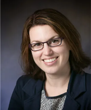 Jennifer Amos in front of a gray backdrop