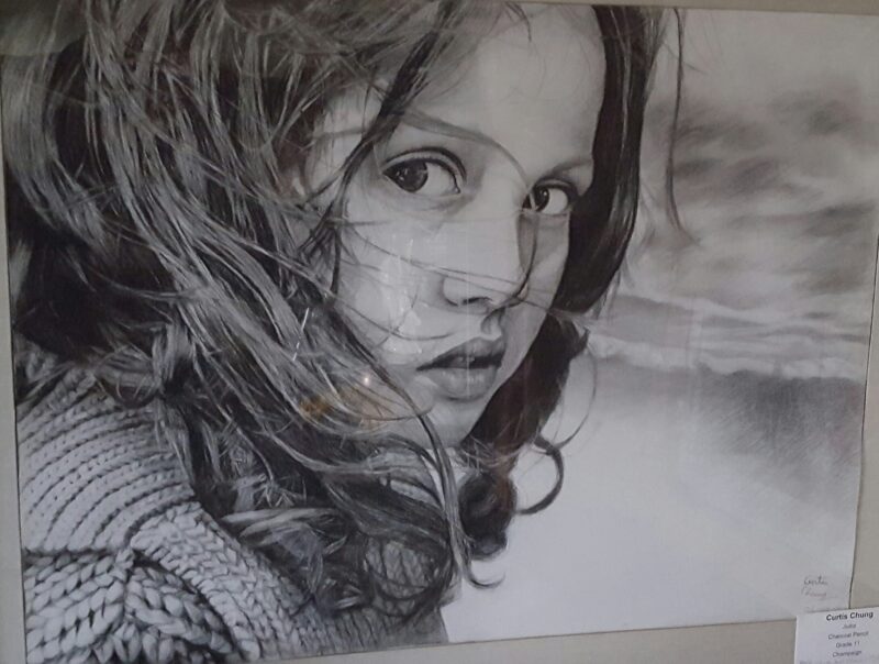 A girl drawn in charcoal.