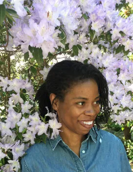 Smiling student amid lavender blooms on a tree