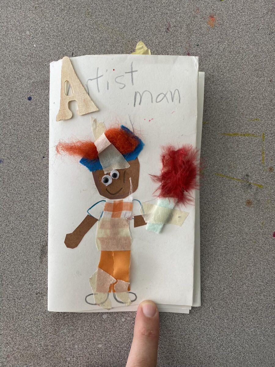 a child's drawing that says "artist man" on it and has a brown child holding a paint brush