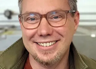 portrait of Eric Benson smiling