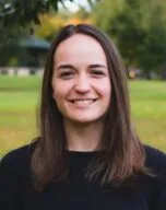 Portrait of the smiling student with a green landscape background