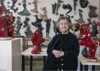 Ruth Migdal in front of her sculptures