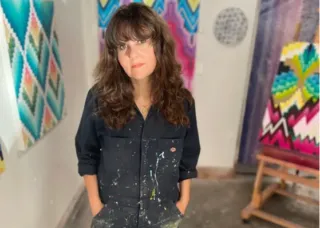 Mary Anna Pomonis full body pic with painted overalls