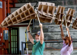 Man and Woman holding carboard fihgure