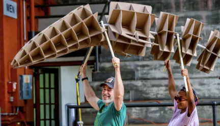 Man and Woman holding carboard fihgure