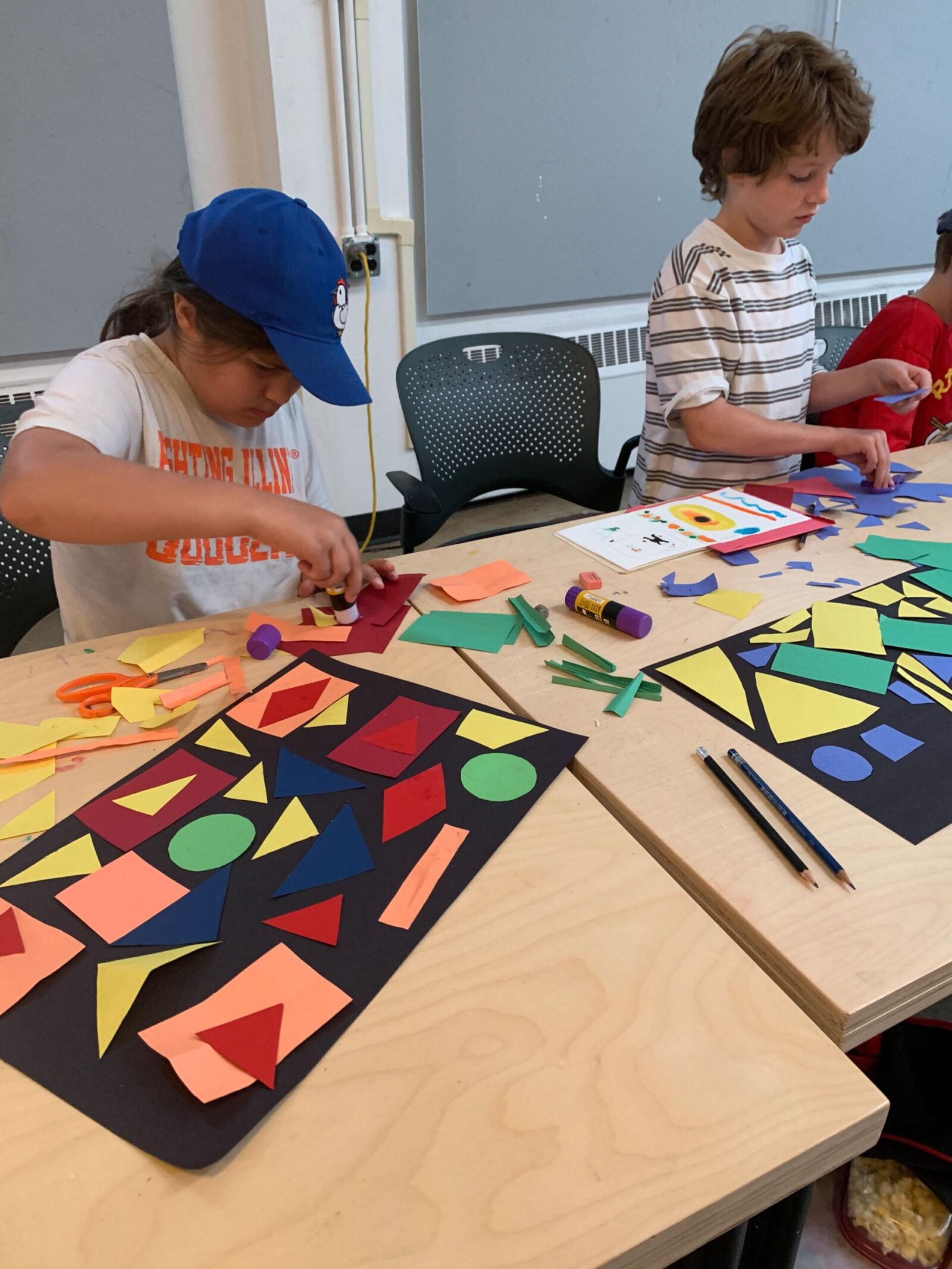 Students working on paper mosaic project