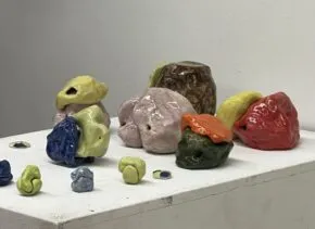 Colorful ceramic forms on a pedestal. 