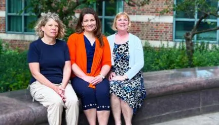 Dr. Stephanie Ceman, Dr. Laura Hetrick, and Dr. Tracey Wszalek sitting on bench outside Beckman Institute