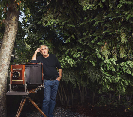 Man standing with camera in forest 