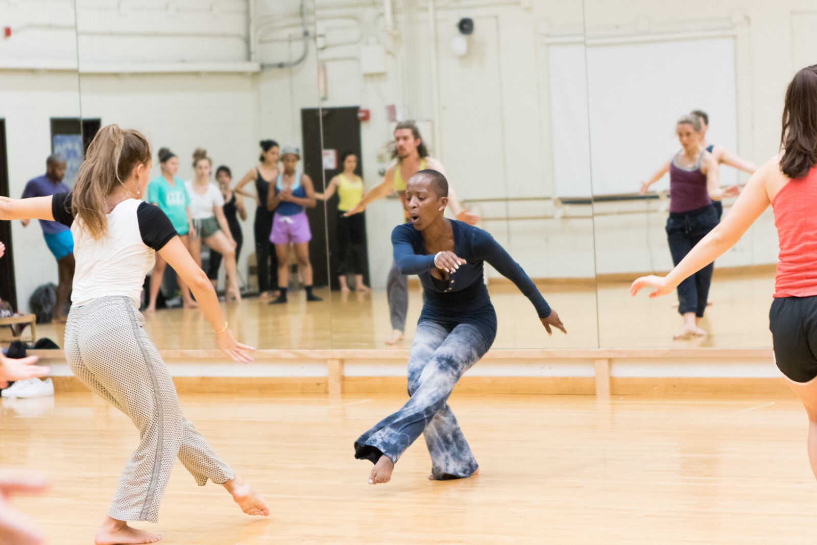 Michelle Gibson dancing and students following in mirror