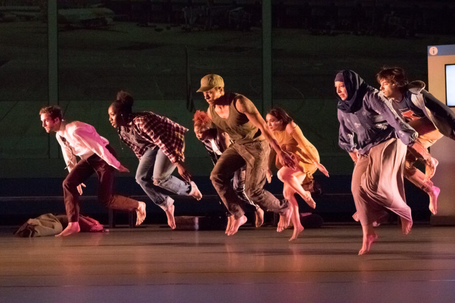 group of dancers with feet off the ground