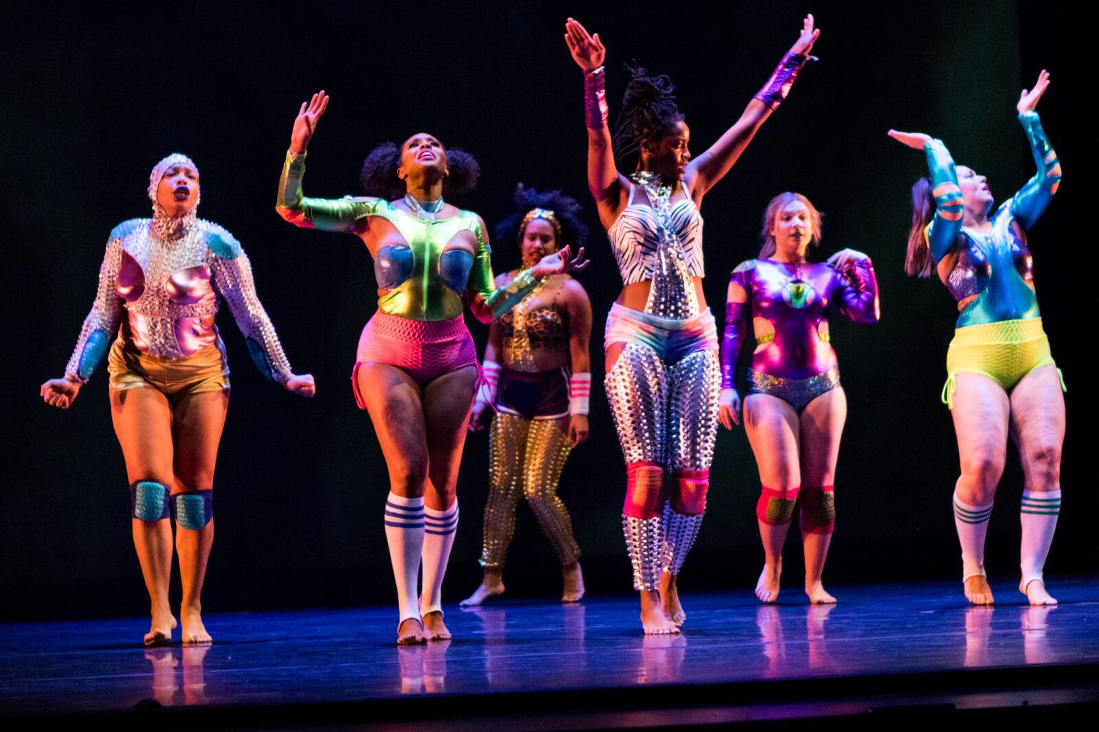 group of dancers with arms up