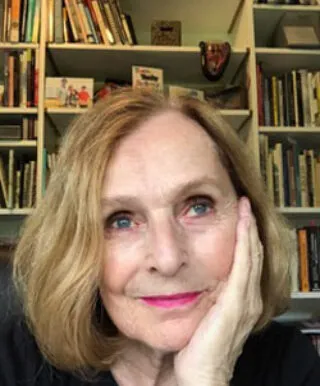 Renee smiling, resting her chin on her hand