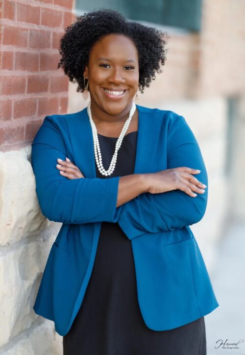 Headshot of Mariam with arms crossed