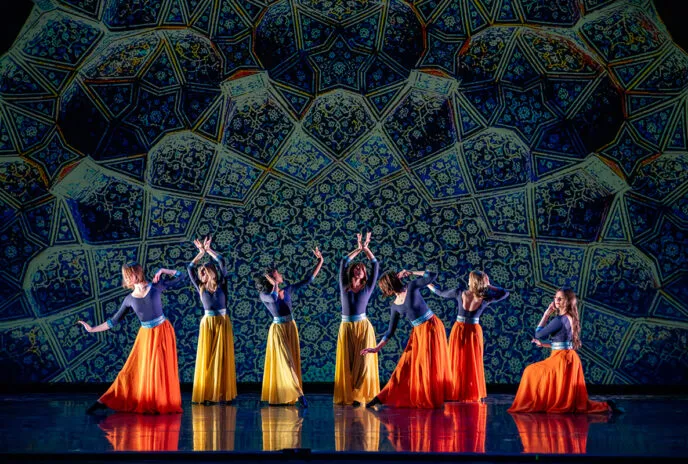 Dancers on stage with green background