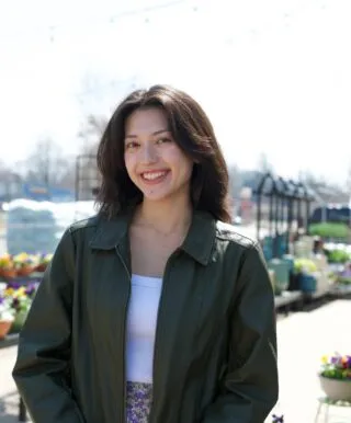 Andrea smiles while outside