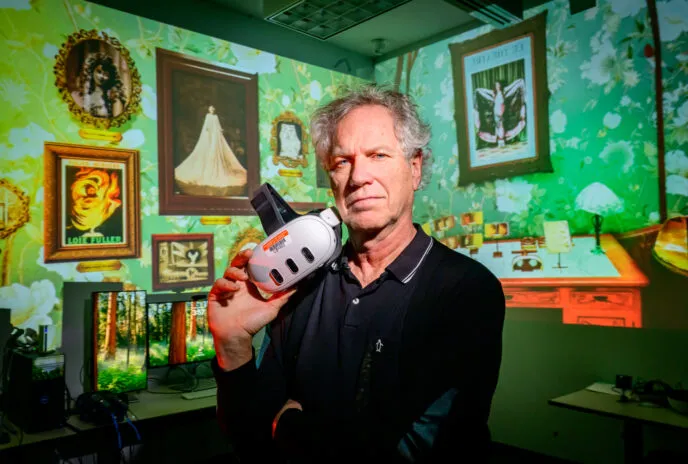 john toenjes holds a virtual reality headset