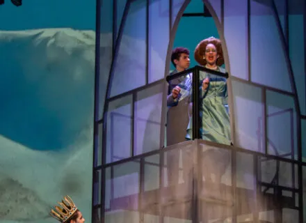 Actors onstage during production with tower made of transparent fabric