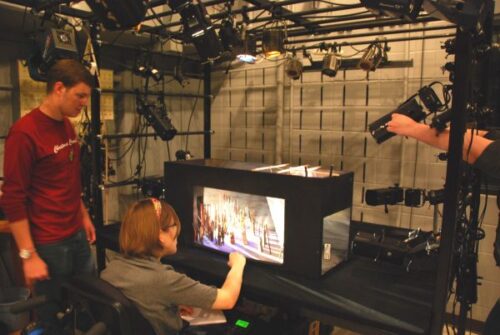 Two students examine a lighting model in the light laboratory 