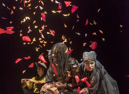 Petals fall on actors in theatre production
