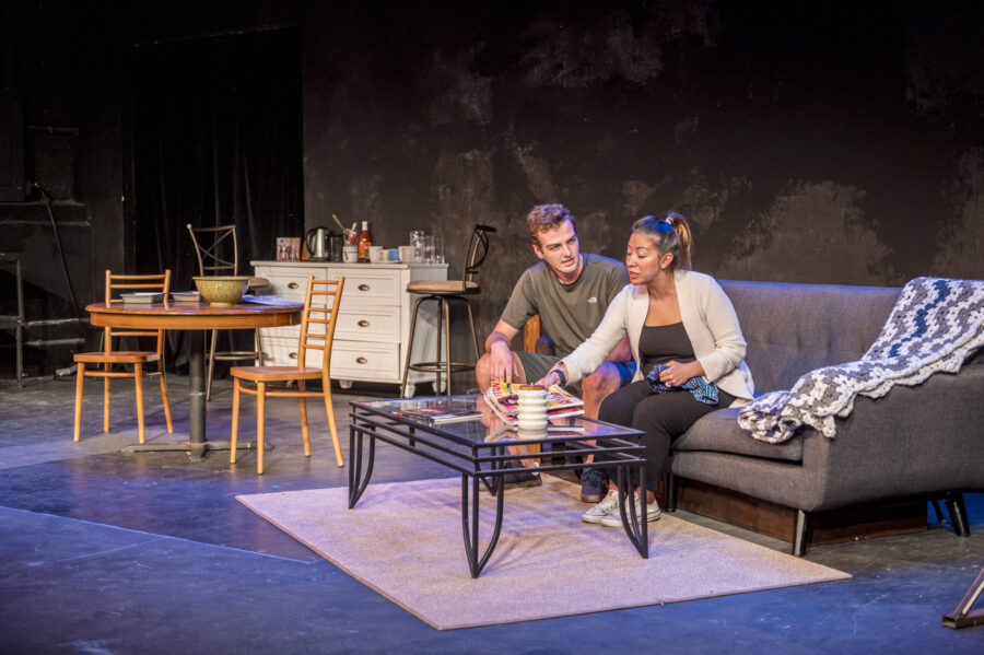 Two actors seated on sofa