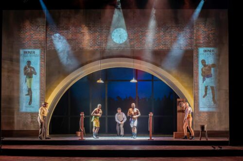 A scene from The Royale at Illinois Theatre shows the stage with 4 actors and lots of lights and scenery element