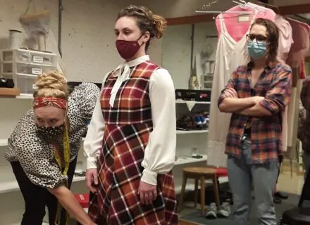 Costume staff conducting a fitting