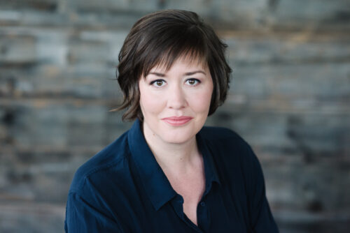 woman with short hair smiles at the camera 