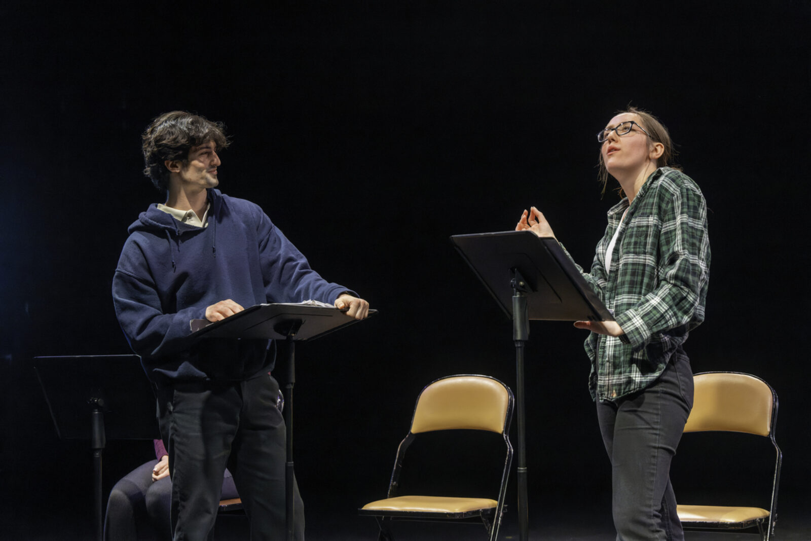 two actors onstage with music stands