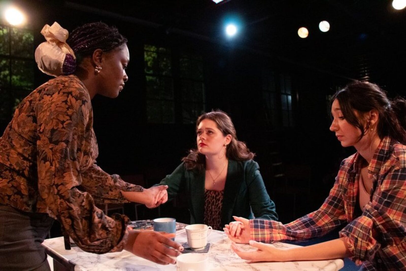 3 people onstage around a table