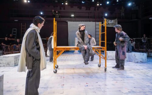 3 actors onstage standing and sitting