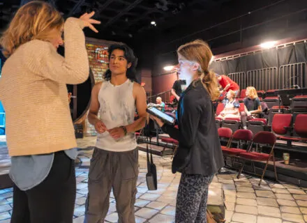 Two actors looking off in the distance during a scene from Tocaya