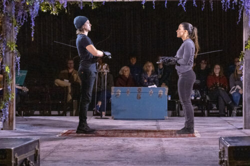 2 people onstage with swords