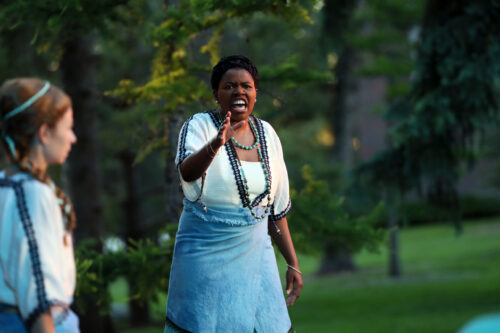 person speaking with arms outstretched
