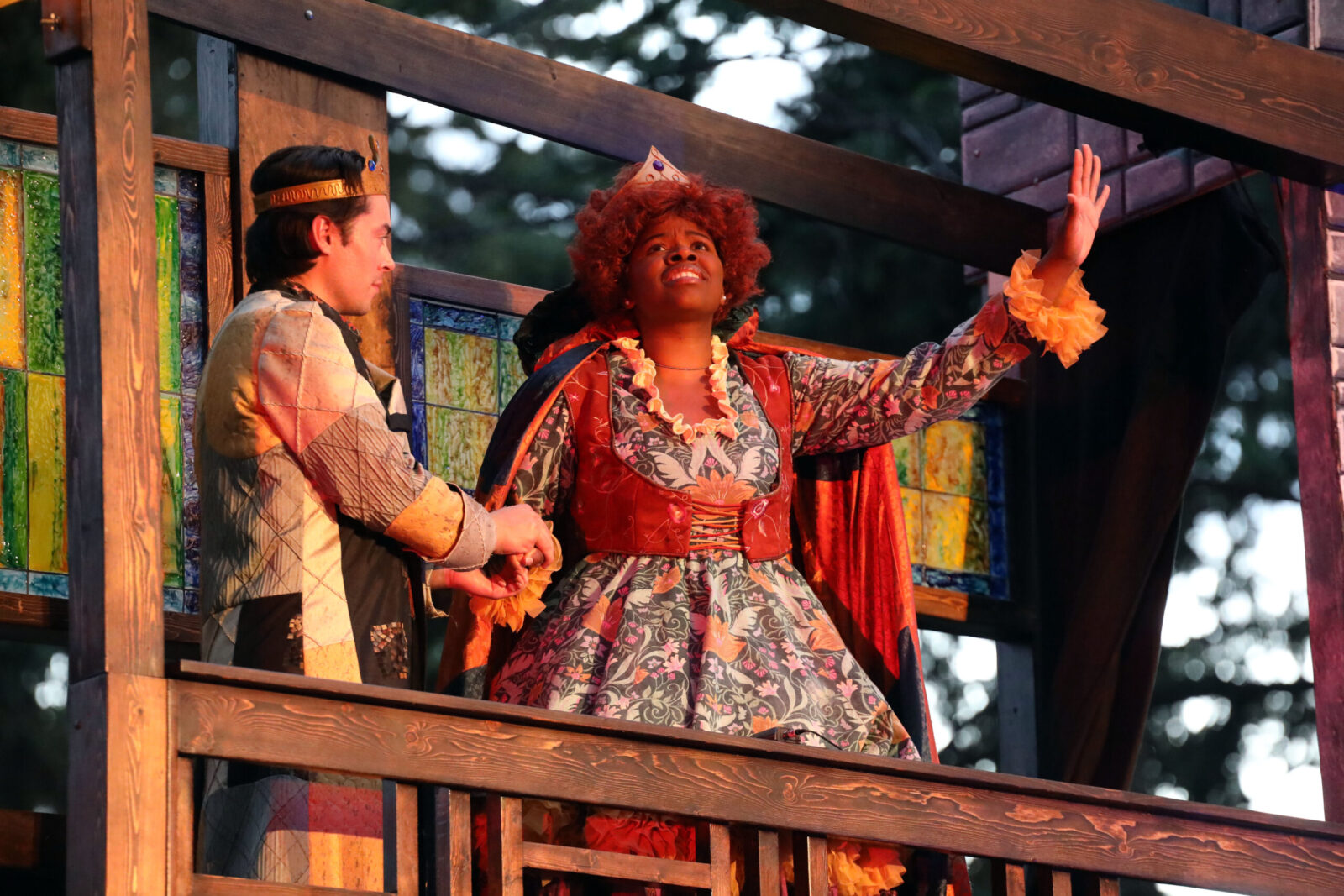 2 people onstage, one with arm stretched out