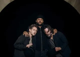 three people with arms around each other