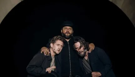 three people with arms around each other