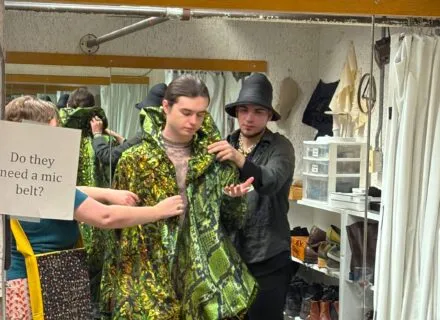 Costume staff conducting a fitting