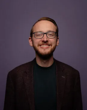 headshot of Matthew smiling and looking at camera