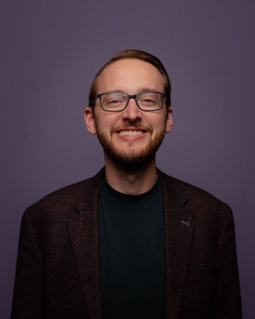 headshot of Matthew smiling and looking at camera