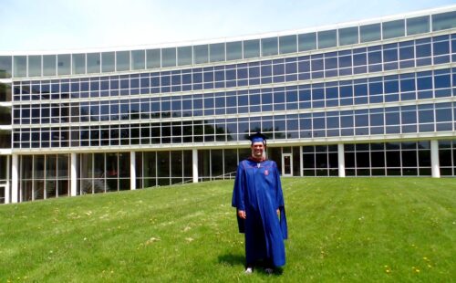 Drew Awsumb (MUP '14) in front of TBH on graduation day.