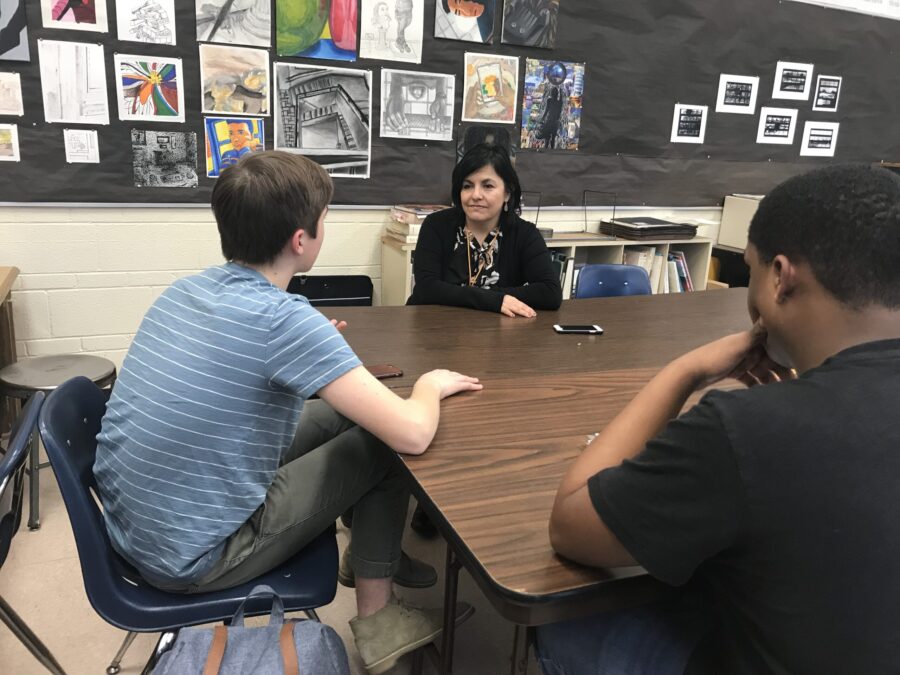 3 figures in a classroom