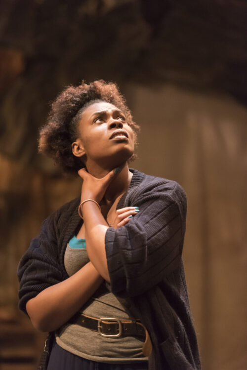 Actress from Illinois Theatre production looking up with arms crossed