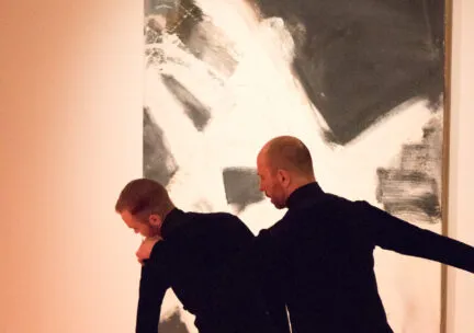 Men dancing in art museum