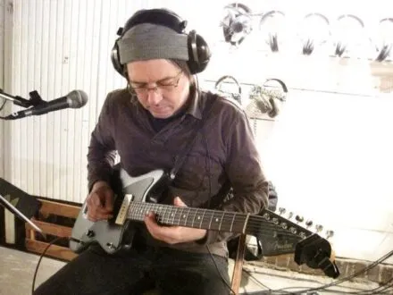 Nick Rudd in the studio playing guitar