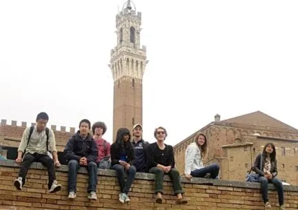 Study abroad students sitting on ledge