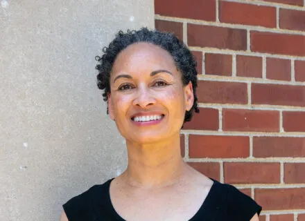 Rebecca Ginsburg by a brick wall